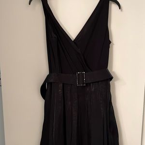 Black cocktail dress with belt and side zipper.  Fit and flare dress size 10.